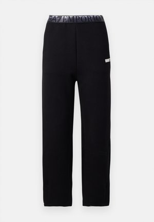 Pantalons de jogging noirs avec une texture lisse et douce, présentant une taille élastique avec un logo et un détail d'accent sur le côté. Conception à jambe droite.