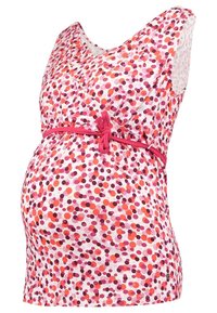 Haut de maternité sans manches à pois roses, rouges et violets, col en V et ceinture nouée à la taille sur fond blanc.