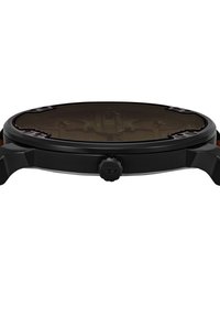 Boîtier de montre en métal noir avec une forme arrondie, présentant un verre teinté sombre et un bouton latéral proéminent pour les réglages.