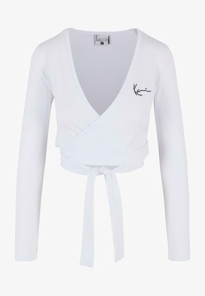 Valkoinen pitkähihaisellinen lyhythihasuinen paita, jossa on kierretty muotoilu, syvä V-pääntie ja solmittava vyötärö. Varustettu brodeeratuilla yksityiskohdilla. Sujuva pinta.