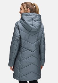 Light gray puffer coat with a hood, featuring a chevron quilted pattern and side pockets, designed for warmth and comfort.