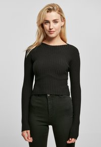 Svart rillede langermet kort genser med rund halsåpning og tettsittende silhuett, med forlengede ermer for ekstra dekning.