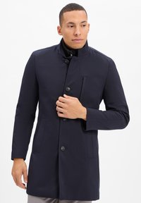 Marineblauer Mantel mit hohem Kragen, vorderem Knopfverschluss und Seitentaschen; glatte Textur und taillierte Passform mit einem eleganten Design.