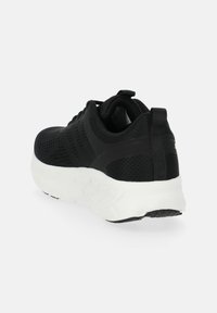 Black athletic sneaker with a mesh upper, white sole, and textured accents. Features a pull tab at the heel for easy wear.