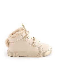 Beige leather high-top shoes with faux fur collar, Velcro straps, and textured rubber sole. Rounded toe and cushioned interior.