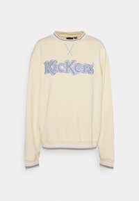 Žlutá mikina z měkké látky s výšivkou loga "Kickers" v šedé barvě, žebrované manžety s modro-bílými pruhy.