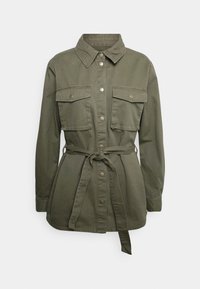 Giacca verde oliva in misto cotone, con bottoni sul davanti, due tasche sul petto e una cintura legata in vita.