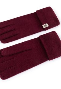 Burgunderfarbene gestrickte Handschuhe mit umgeschlagenem Bündchen, ausgestattet mit einem kleinen Stoffetikett. Die Textur ist weich und das Material wirkt warm und langlebig.