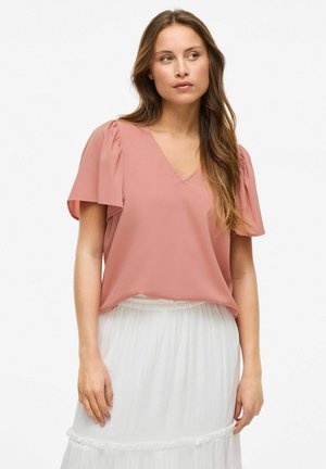 Blouse rose à manches courtes avec un col en V, dotée d'accents plissés sur les manches. Conçue avec une coupe ample et en tissu léger.