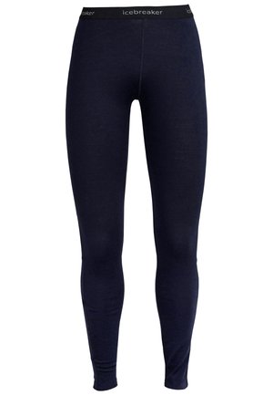 Navy leggings made of a soft material, featuring an elastic waistband with "icebreaker" logo. Fitted design with no visible seams.