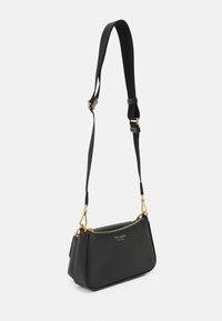 Black leather shoulder bag with gold hardware, zip closure, and adjustable fabric strap. Smooth texture with a structured shape.