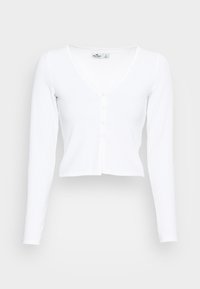 Bílý žebrovaný top s dlouhým rukávem a výstřihem do V, se zapínáním na pět knoflíků. Má zkrácený design a měkkou strukturovanou tkaninu.