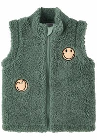 Fleece liivi hillityssä vihreässä, korkealla kauluksella, edessä vetoketju ja kaksi hymyilevää kasvoa -painatusta edessä. Pehmeä, tekstuuri kangas.