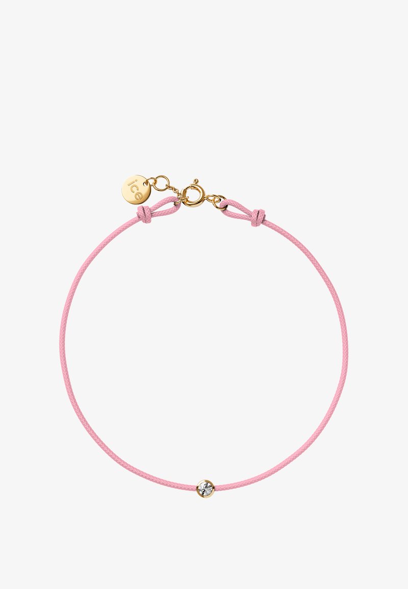 Pink cord bracelet with a gold clasp and a single crystal accent. Smooth texture and simple design, featuring a branding tag.