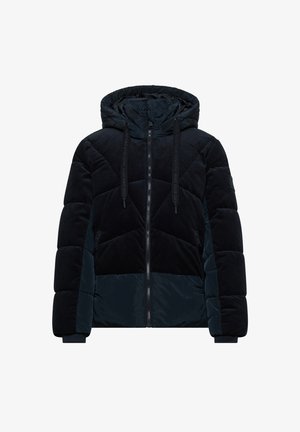Marineblå pufferjakke med hætte, der har både fløjl og glatte stofstrukturer, quiltet design og to lynlåslommer på siderne.