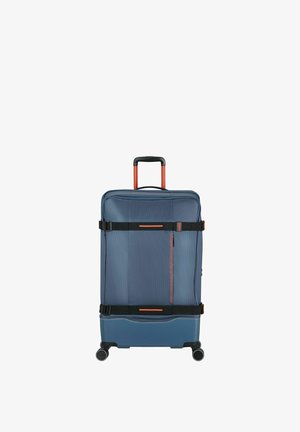 Valise à roulettes bleue avec sangles de compression réglables noires et orange et poignée télescopique déployée.