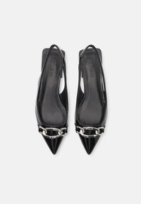 Black patent leather slingback shoes with pointed toes and silver chain detail across the front. Smooth texture and minimalistic design.