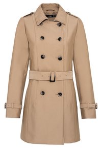 Trench-coat beige à double boutonnage avec ceinture, épaulettes et sangles de manches boutonnées.