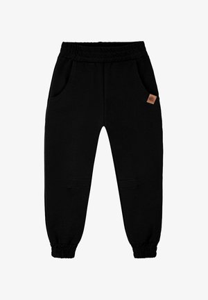 Czarne spodnie dresowe wykonane z miękkiego materiału, posiadające ściągacz w pasie na troczki, dwie boczne kieszenie oraz małą skórzaną naszywkę z logo na przodzie.