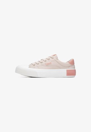 Zapatillas de lona rosa claro con puntera y suela de goma blanca, con detalles cosidos y una etiqueta con logotipo en el lateral. Textura suave.