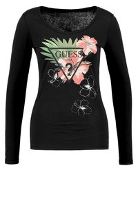 Schwarzes Langarm-T-Shirt mit einem runden Ausschnitt, das ein florales Motiv und das Wort "GUESS" in einem Dreiecksdesign zeigt. Weicher, elastischer Stoff.