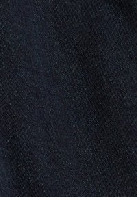 Mörkblå denimtygtextur med synlig diagonal vävningsmönster och subtila variationer i trådfärg.