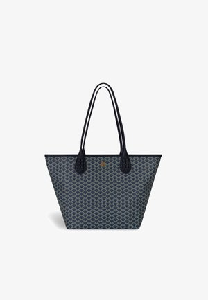 Navy tote bag with a scalloped pattern. Made of textured material, features two long straps and a gold emblem. Accents include braided strap ends.