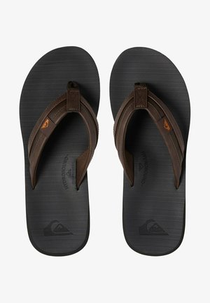 Brown leather flip-flops with black rubber soles. Textured footbed featuring brand logo. Adjustable straps for comfort.