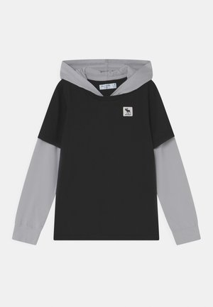 Czarna bluza z kapturem z jasnoszarymi długimi rękawami i kapturem, mała biała naszywka z logo łosia na lewej piersi, metka z rozmiarem dla dzieci wewnątrz kołnierza.