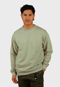 Lichtgroene, geribde sweatshirt met lange mouwen, ronde hals en geborduurd logo. Heeft een relaxte pasvorm en een gewafeld materiaal.