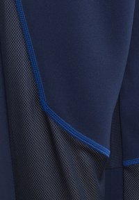 Navy athletic fabric with mesh side panels. Features flat seams and a contrasting blue border. Smooth texture with a breathable design.