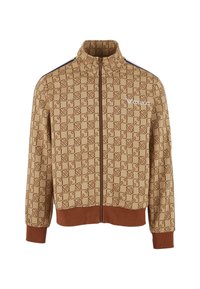 Brown and beige zip-up jacket made of textured fabric featuring a repeating geometric pattern and ribbed cuffs and hem.