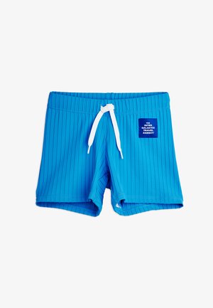 Blue ribbed swim shorts with white drawstring and a patch reading "The Inter Galactic Travel Agency" on the front right side.