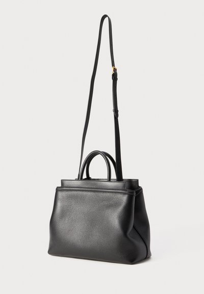 Mustan nahkalaukun rakenne on jämäkkä, ja siinä on yläkahvat sekä pitkä, säädettävä olkahihna. Laukussa on teksturoitu pinta ja minimalistinen muotoilu.