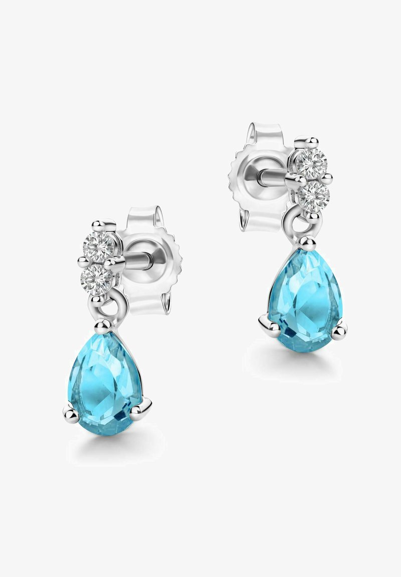 Gli orecchini a goccia presentano una grande pietra preziosa blu sfaccettata e due diamanti più piccoli. Un contorno e un supporto in metallo argentato valorizzano il design.
