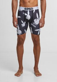 Boxers noirs avec un motif ludique de lapin blanc, mettant en avant un design texturé et une ceinture blanche contrastante avec le logo "PSD".