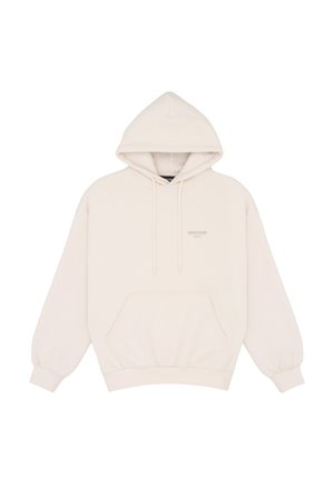 Sweat à capuche beige oversize avec poche avant, capuche à cordon, poignets côtelés et texte de marque subtil sur le côté gauche de la poitrine.