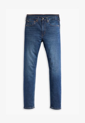 Mėlyni džinsai su slim fit siluetu, turi penkis kišenes, užtrauktuką ir kontrastingus siūlus. Audinys yra lygus, vidutinio svorio.