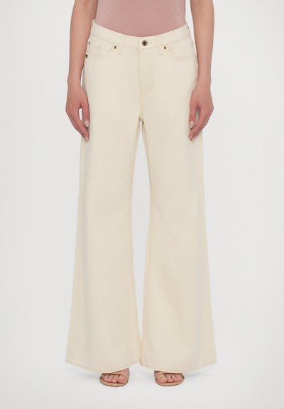 Wide-leg jeans in light beige cotton, featuring a button closure, two front pockets, minimal stitching, and a relaxed fit.