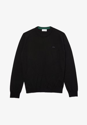 Pull noir à col rond en coton, avec des bords-côtes aux poignets et à l'ourlet, comportant un petit logo Lacoste noir sur la poitrine.