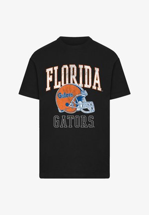 Schwarzes Baumwoll-T-Shirt mit dem Schriftzug "FLORIDA" in orangefarbener, abgenutzter Schrift über einem blauen Football-Helm und "GATORS" in Weiß darunter.