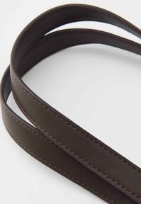 Dark brown leather belt with subtle stitching, coiled on a light gray background, showing smooth texture and clean edges.