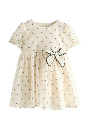 Helebeež kleit hallide täppidega, lühikeste puhvärvadega ja kogutud vöökohaga. Ees on kaunistuseks nool, millel on laineline äär.