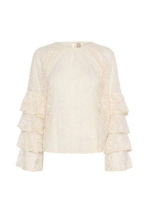 Blouse en dentelle blanc cassé avec un col rond et des manches à volants superposées. Dotée d'un motif floral texturé et d'un dos en forme de trou de serrure.