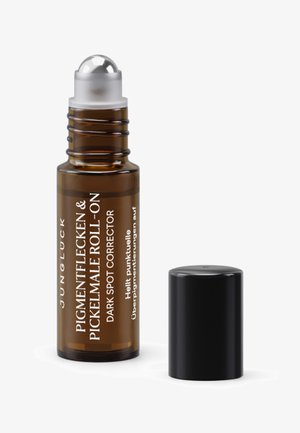 Brown glass roll-on bottle with silver ball applicator, black cap, white and silver text. Contains dark spot corrector.