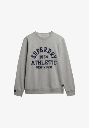 Szary bawełnowy sweatshirt z granatowym napisem "SUPERDRY 1954 ATHLETIC NEW YORK". Prążkowane mankiety i dół, okrągły dekolt, luźny krój.