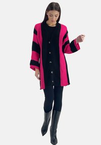 Gebreide cardigan met roze en zwarte strepen, voorzien van een V-hals, knopenclosure en driekwart mouwen. Gelaagd stof en ontspannen pasvorm.