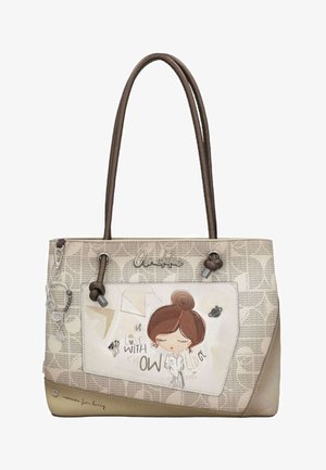 Borsa beige e marrone con manici lunghi, con illustrazione di una ragazza dei cartoni animati e scritta "Innamorata della conoscenza."
