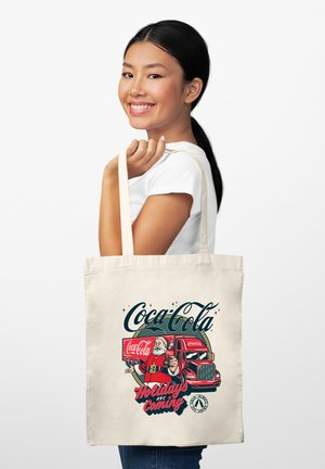Borsa tote in tela di colore naturale caratterizzata da una grafica Coca-Cola con un Babbo Natale vintage e un camion di consegna, testo "Le festività stanno arrivando."