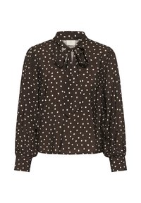 Blouse noire à manches longues avec des pois blancs, un nœud papillon au col et des poignets boutonnés aux manches.